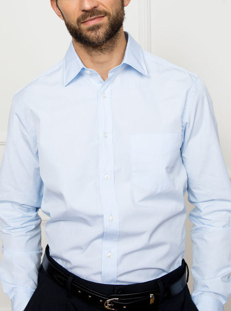 Man wearing sky blue long sleeved shirt made with 100% Royal Oxford Cotton.